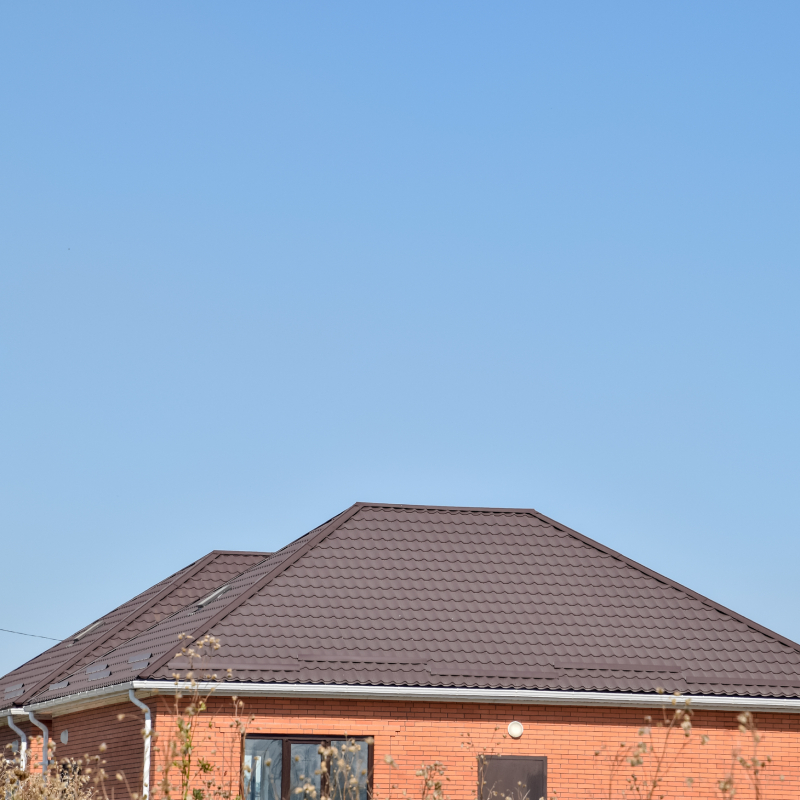 Detached house with a roof made of steel sheets. Roof metal sheets. Modern types of roofing materials.