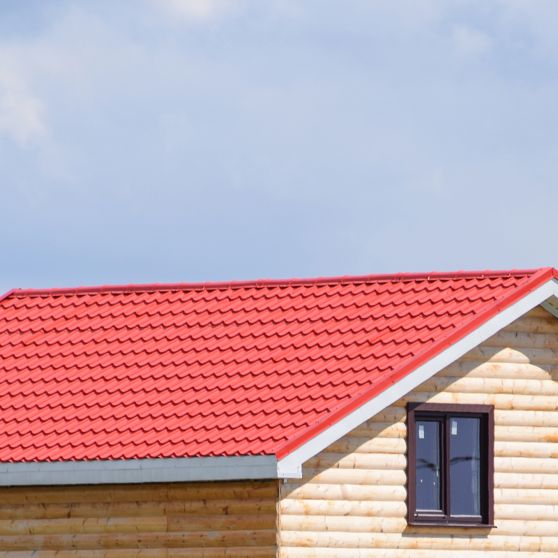 The roof of corrugated sheet on the houses. Individual homes with roof made of profiled sheet metal.